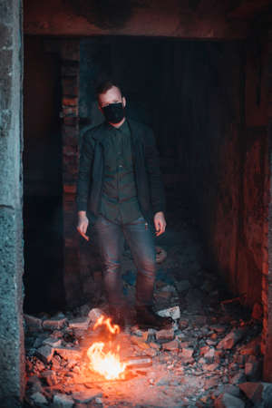 Post Apocalypse portrait of young man near the flaming molotov cocktailの写真素材