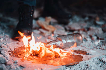 Cocktail molotov flaming near heavy boots of protesterの写真素材
