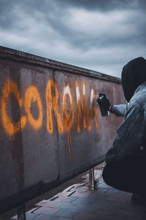 Protester writing the corona signature on abandoned wallの写真素材