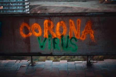 Acid colored corona virus sign on old wallの写真素材