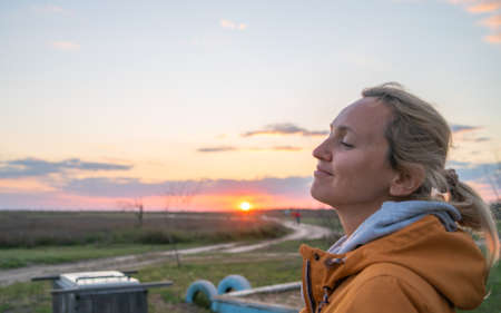 Charming adult blonde likes to catch sunsetの写真素材