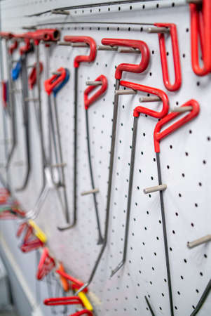 Bright colored special hooks using in PDR work process to remove dents on a standの写真素材