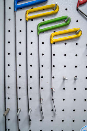 Bright colored special hooks using in PDR work process to remove dents on a standの写真素材
