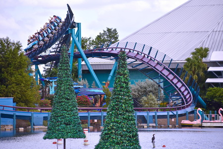 Orlando, Florida. October 19, 2018 Amazing rollercoaster and Christmas Trees on lake at Seaworld Theme Park.のeditorial素材