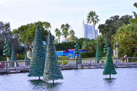 Orlando, Florida. October 19, 2018 People leaving the park and beautiful Christmas Tree over lake on cloudy sky background at Seaworld Theme Park.のeditorial素材