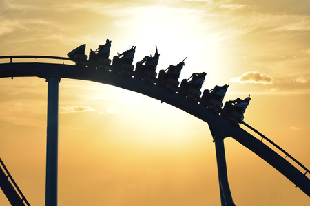 Orlando, Florida. September 21, 2018. Funny people riding Mako Rollercoaster at Seaworld on beautiful sunset background.のeditorial素材