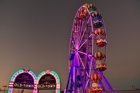Orlando, Florida; October 31, 2018 Colofur Arches and Ferris Wheel on sunset background at Old Town Kissimmee in 192 Highway area.のeditorial素材