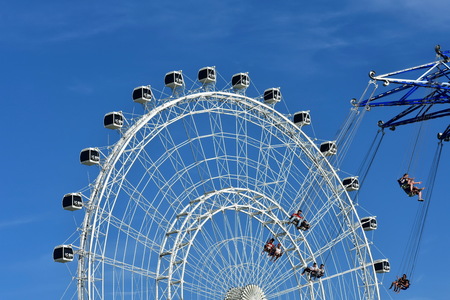 Orlando, Florida. October 19, 2018 People enjoying Star Flyer on big wheele background and blue sky at International Drive area.のeditorial素材