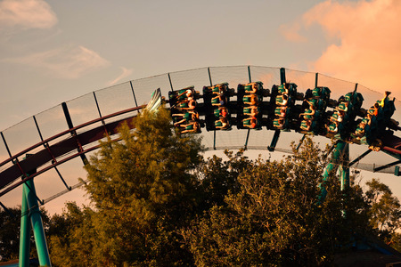Orlando, Florida. November 19, 2018. People having fun Mako Rollercoaster on sunset background in International Drive area.のeditorial素材