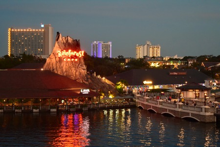 Orlando, Florida. November 24, 2018 Panoramic view of Volcano reflected in Lake, vintage bridge and Hotel buildings at night in Lake Buena Vistaのeditorial素材