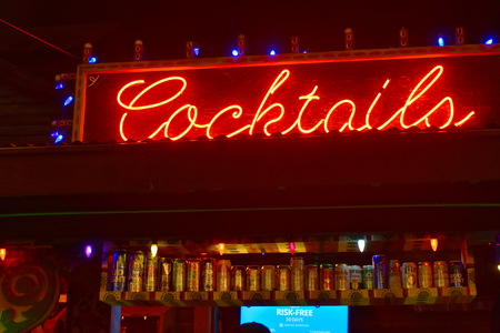 Orlando, Florida. November 24, 2018 Illuminated cocktails sign and nice shelf with beer cans at Lake Buena Vista.のeditorial素材