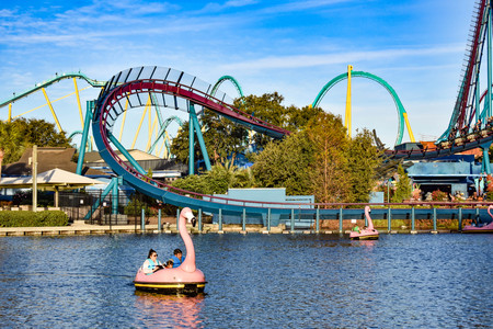 Orlando, Florida. December 19, 2018. at Seaworld Panoramic view of rollercoaster and flamingo boat ride on blue lake in International Drive area (4)のeditorial素材