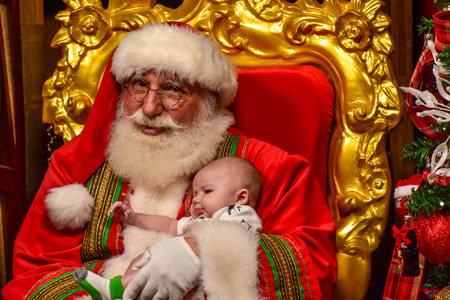 Orlando, Florida. December 19, 2018. Funny Santa and sweet baby at Seaworld in International Drive area.のeditorial素材