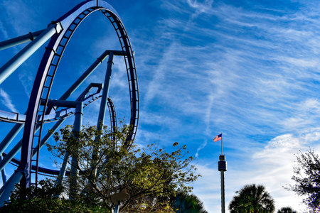Orlando, Florida. December 19, 2018. Top view of rollercoaster and Sky Tower with USA Flag at...