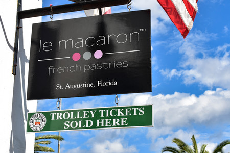 St. Augustine, Florida. January 26, 2019. Le Macaron Pastries an Trolley Tickets signs at Old Town in Floridas Historic Coast.のeditorial素材
