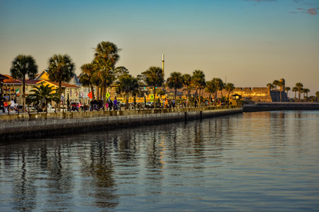 St. Augustine, Florida. January 26, 2019. People walking on boardwalk on sunset at Old Town in...