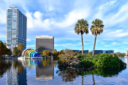 Orlando, Florida . December 24, 2018. Palm trees in small island, colorful amphitheater and buildings at Lake Eola Park in Orlando Downtown area.のeditorial素材