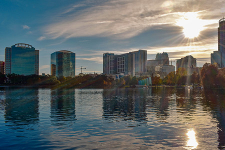 Orlando, Florida . December 24, 2018. Colorful buildings and beautiful sunset with sun reflected in lake in Orlando Downtown area.のeditorial素材