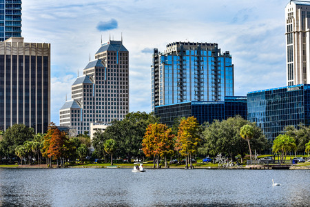 Orlando, Florida. December 24, 2018 Colorful buildings, autumn forest and swan boats in Eola Lake Park at Orlando Downtown (2)のeditorial素材