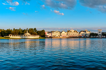 Orlando, Florida. February 09, 2019. Panoramic view of beautiful Victorian ride on dockside and restaurants on lightblue cloudy background at Lake Buena Vista area.のeditorial素材