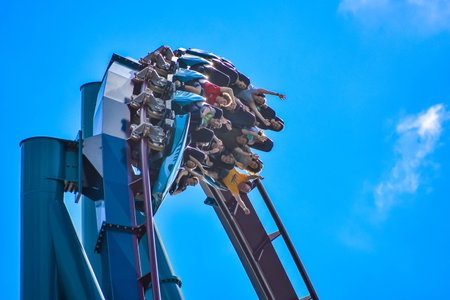 Orlando, Florida . February 26, 2019. People enjoying amazing Mako rollercoaster on lightblue sky...