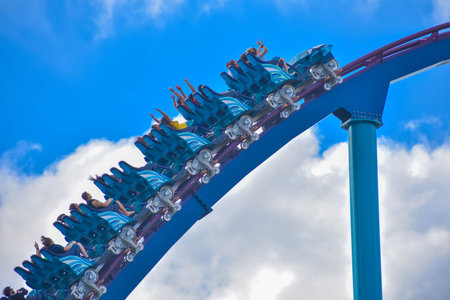 Orlando, Florida . February 26, 2019. People enjoying amazing Mako rollercoaster on lightblue sky...