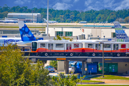 Orlando, Florida. March 01, 2019. Roll-on-off train and partial view of aircraft at Orlando International Airport (2)のeditorial素材