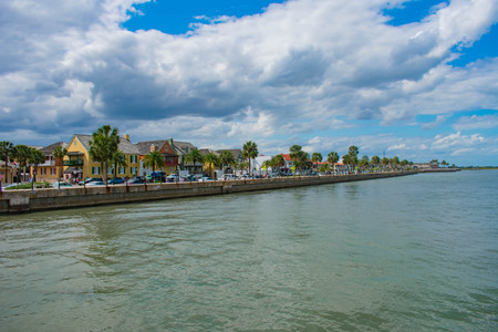 St. Augustine, Florida. March 31, 2019. Colorful boardwalk, palm trees and partial view of San Marcos Fort Fort in Florida's Historic Coast.のeditorial素材