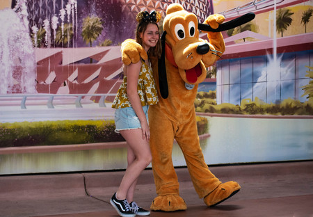 Orlando, Florida . March 27, 2019. Pluto hugging girl at Epcot in Walt Disney World (2)のeditorial素材