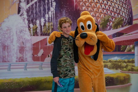 Orlando, Florida . March 27, 2019.Pluto hugging little boy at Epcot in Walt Disney World.のeditorial素材