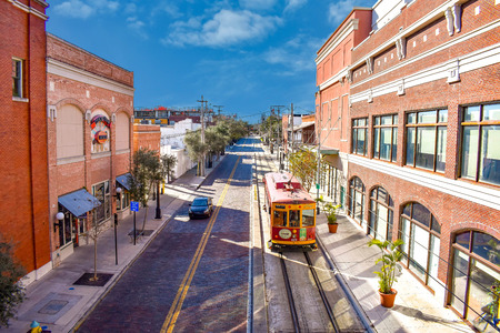 Ybor City Tampa Bay, Florida. January 19, 2019. Top view of Street Car and vintage buildings in 8th Ave on sky blue background.のeditorial素材