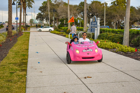 Clearwater Beach, Florida. January 25, 2019 Family enjoying pink scoot coupe close to Piere 60 area in Gulf Coast Beaches (1)のeditorial素材