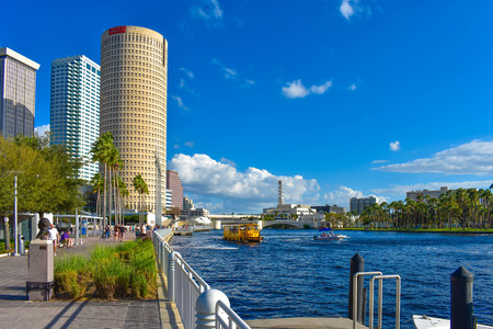 Tampa Bay, Florida. March 02, 2019. Partial view of skycrapers, riverwalk and water taxi sailing on Hillsborough river in downtown area.のeditorial素材