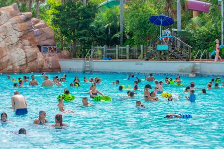 Orlando, Florida. April 07, 2019. Parent and kids enjoying pool with lightblue water at Aquatica water park.のeditorial素材