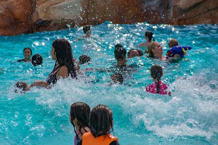 Orlando, Florida. April 07, 2019. Parents and kids having fun pool on bluelight water at Aquatica (2)のeditorial素材