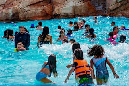Orlando, Florida. April 07, 2019. Parents and kids having fun pool on bluelight water at Aquatica (3)のeditorial素材