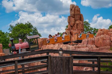 Orlando, Florida. May 10, 2019. People having fun Big Thunder Mountain railroad on cloudy sky background in Magic Kingdom at Walt Disney World (8)のeditorial素材