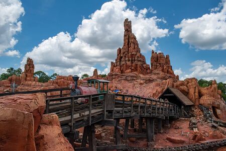 Orlando, Florida. May 10, 2019. People having fun Big Thunder Mountain railroad on cloudy sky background in Magic Kingdom at Walt Disney World (9)のeditorial素材