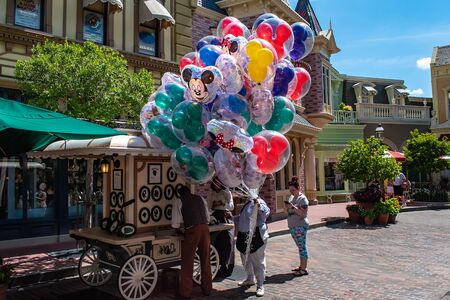 Orlando, Florida. May 10, 2019. Person selling colorful Mickey balloons in Magic Kingdom at Walt Disney World.のeditorial素材