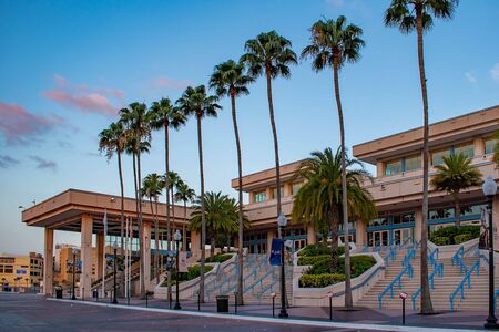 Tampa Bay, Florida. April 28, 2019. Tampa Convention Center and palm trees on sunrise background (1)のeditorial素材