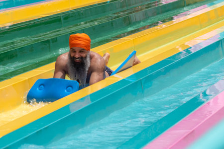 Orlando, Florida. July 01, 2019. Hindu man enjoying amazing splashing in Tamauta Racer attraction at...