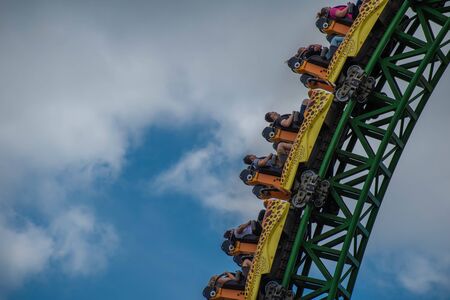 Tampa Bay, Florida. August 08, 2019. People amazing terrific Cheetah Hunt rollercoaster on lightblue cloudy sky background 84のeditorial素材