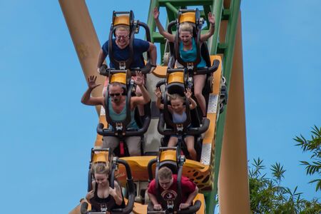 Tampa Bay, Florida. August 08, 2019. People amazing terrific Cheetah Hunt rollercoaster on lightblue cloudy sky background 86のeditorial素材