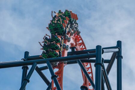 Tampa Bay, Florida. August 08, 2019. People enjoying terrific Tigris rollercoaster on lightblue cloudy sky background 12のeditorial素材