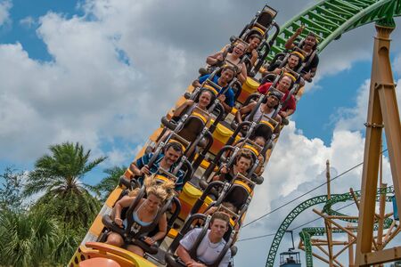 Tampa Bay, Florida. August 08, 2019. People having fun terrific Cheetah Hunt rollercoaster on lightblue cloudy sky background 18のeditorial素材