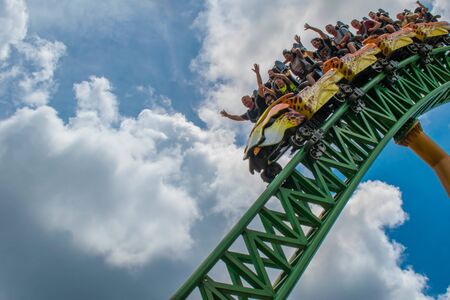 Tampa Bay, Florida. August 08, 2019. People having fun terrific Cheetah Hunt rollercoaster on lightblue cloudy sky background 67のeditorial素材