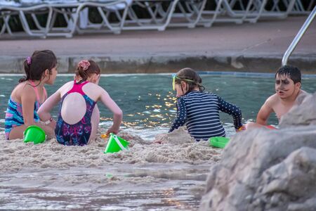 Orlando, Florida. October 11, 2019. Childs playing with sand in hotel pool area at Lake Buena Vista 2のeditorial素材