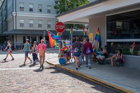 Orlando, Florida. October 12, 2019. Couple selling rainbow flag in corner in Come Out With Pride Orlando parade at Lake Eola Park area 181のeditorial素材