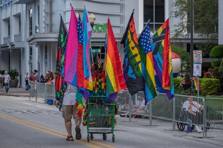 Orlando, Florida. October 12, 2019. Man selling colorful flags and caps in Come Out With Pride Orlando parade at Lake Eola Park area 197のeditorial素材