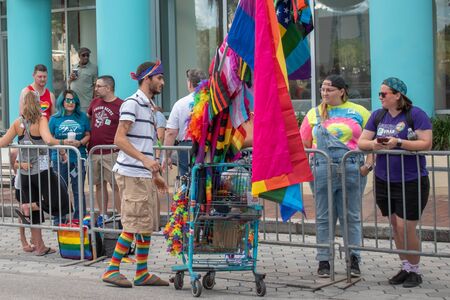 Orlando, Florida. October 12, 2019. Nice man selling colorful flags and caps in Come Out With Pride Orlando parade at Lake Eola Park area 197のeditorial素材
